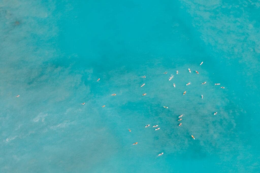 blue sea with boats visible from a drone shot
