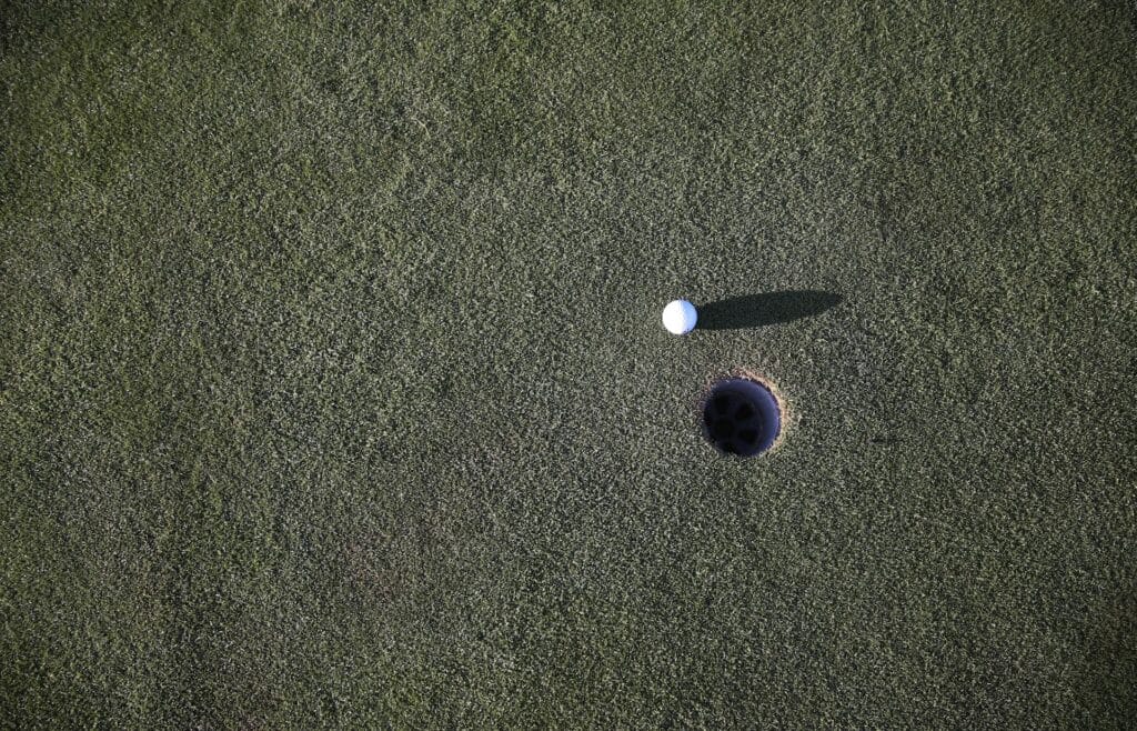 gold ball and hole showcasing potential being wasted