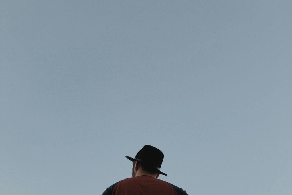 man with a hat sitting alone
